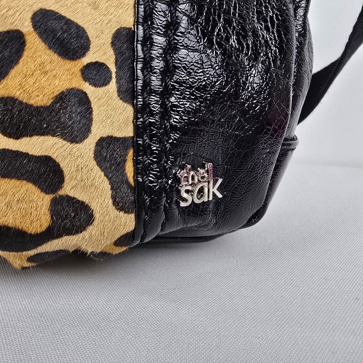 The Sak Black Leather Animal Print Pouch Crossbody Purse