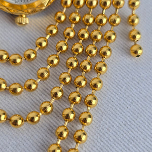 Vintage Gold Tone Quartz Brooch Watch with Cascading Bead Chain Swags