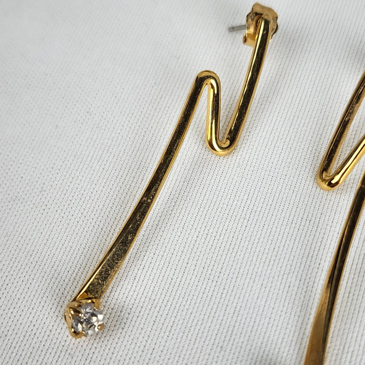Gold Tone Swoosh Crystal Stud Earrings