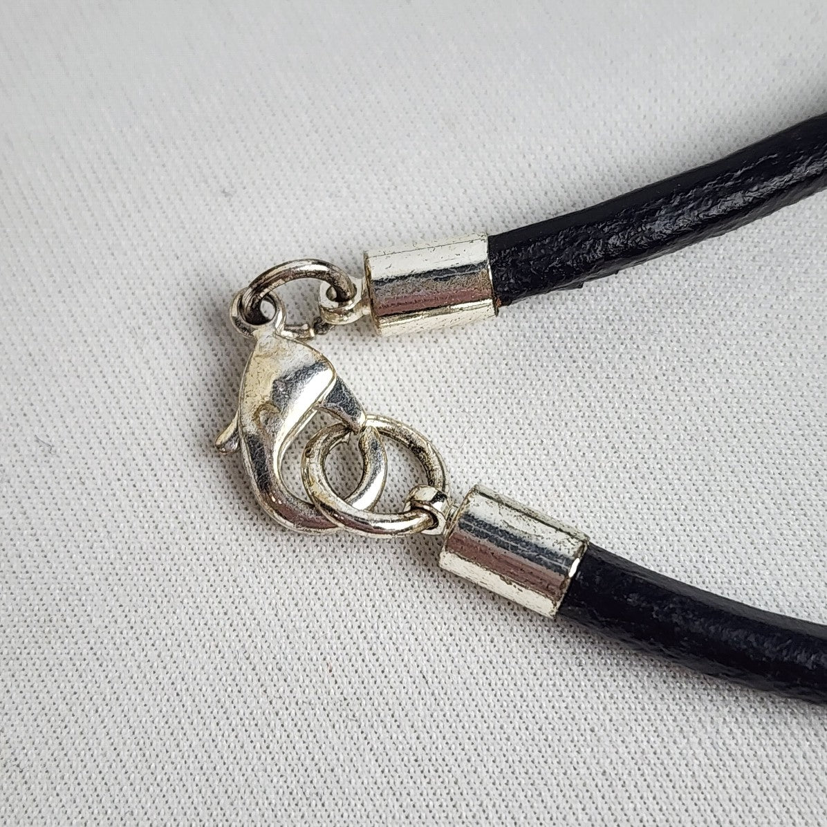 Silver Tone Oval Pendant Black Cord Necklace